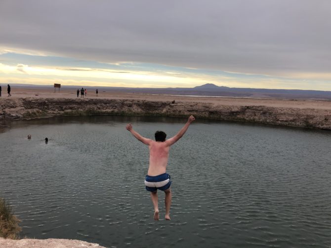 Jumping into the Ojos del Salar (ignore the sunburnt back)