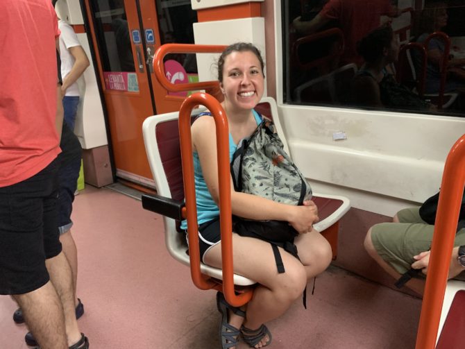 Randi on the Underground. The little clusters of chairs reminded us of a theme-park ride.