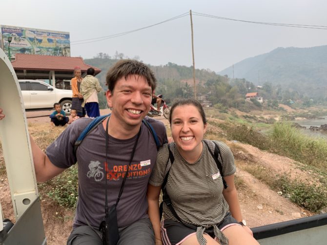 Perched precariously on the side of the tuk tuk carrying our bags up the hill from the boat