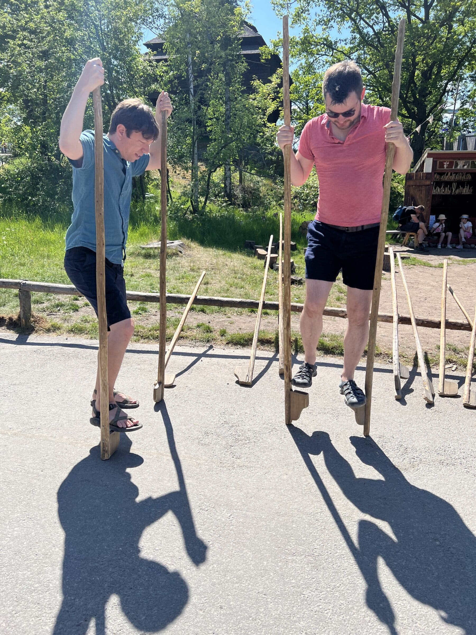 Trying out stilts at Skansen, before a passing stranger pointed out we had them backwards